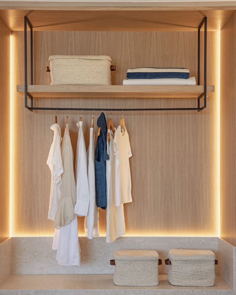 Open wardrobe and storage area in Grecotel Creta Palace room