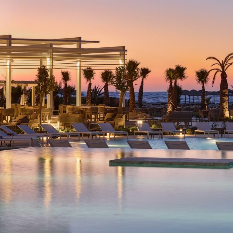 Brasserie Ariadne pool area overlooking the sea at sunset