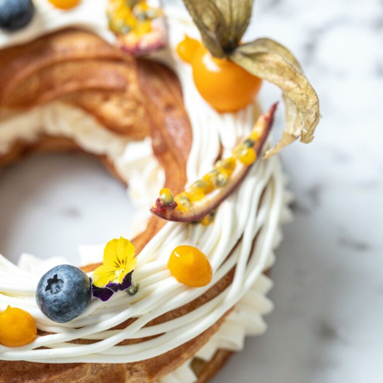 Gourmet fruit tart with cream, berries and edible flowers at Grecotel Creta Palace