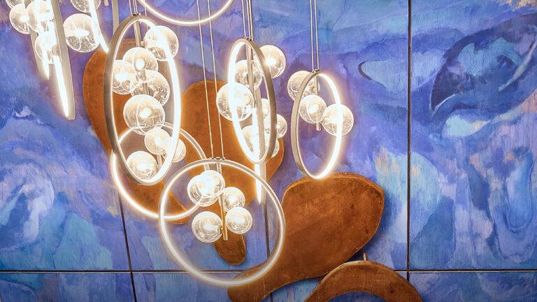 Large-scale blue artwork by Greek artist Io Aggeli displayed across the interior of Grecotel Creta Palace.