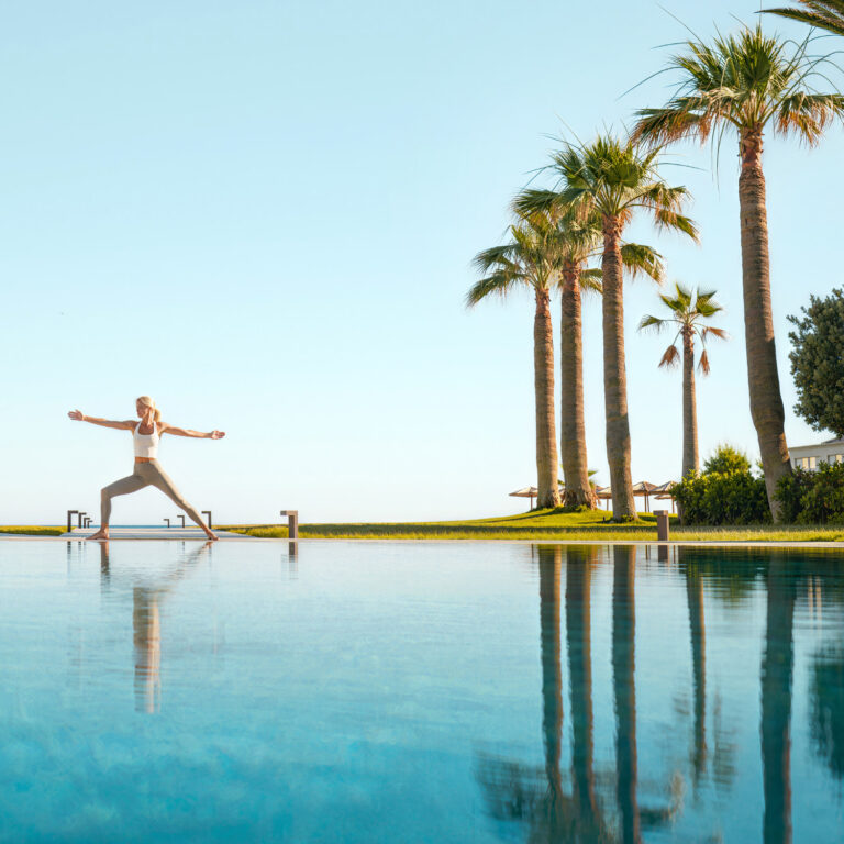 Outdoor yoga session overlooking the sea at Grecotel Creta Palace.