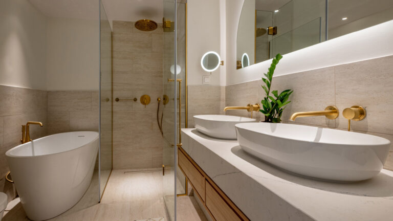 Bathroom with bathtub, walk-in shower and double vanity in the Deluxe Room Veranda at Filoxenia Kalamata