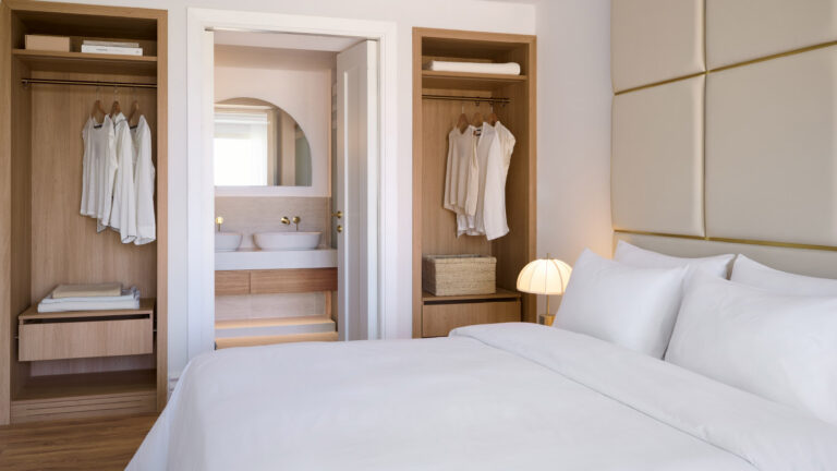 Two Bedroom Luxury Suite bedroom with open wardrobes and bathroom access