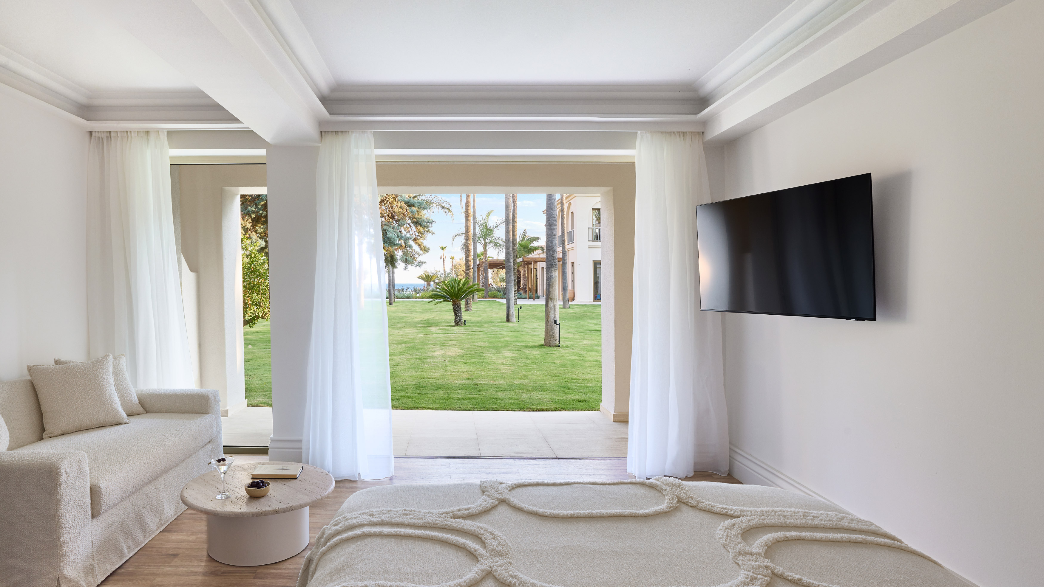 Deluxe Room Veranda bedroom with sitting area and garden view at Filoxenia Kalamata