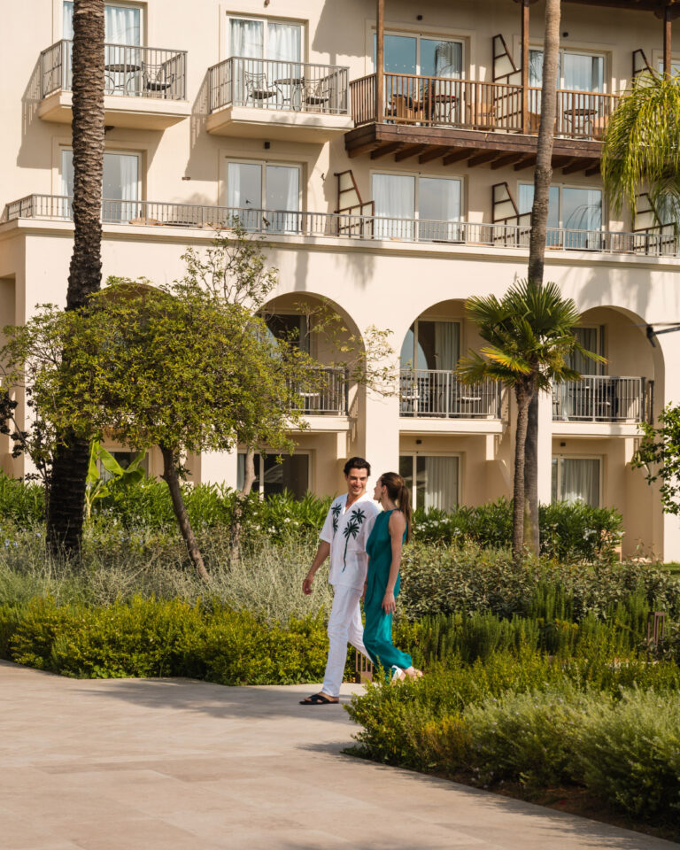 Couple walking through the landscaped gardens at Filoxenia Kalamata