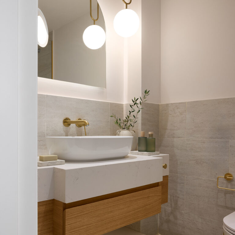 Bathroom vanity with brass fixtures in the Two Bedroom Luxury Suite with Garden