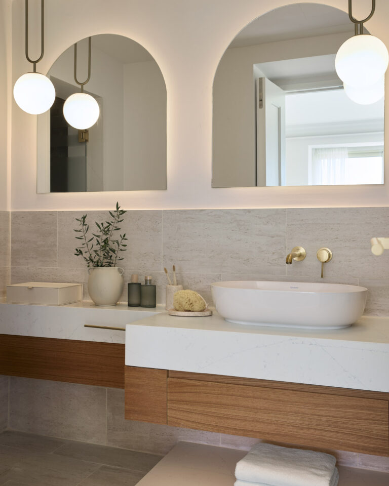 Deluxe Suite Seafront bathroom with marble vanity and brass fixtures