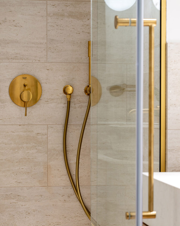 Walk-in shower with brass fixtures in the Deluxe Room Veranda at Filoxenia Kalamata