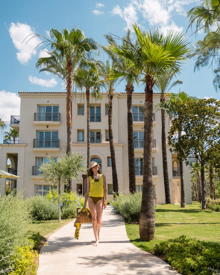 Guest walking through the landscaped gardens at Filoxenia Kalamata