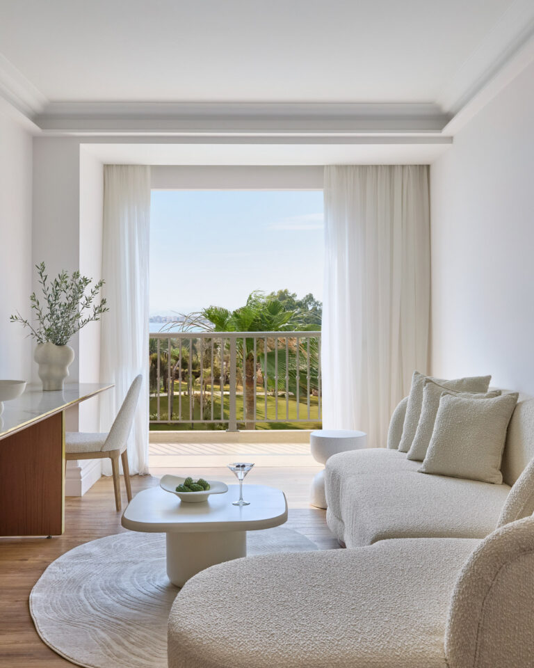 Deluxe Suite Seafront living area with balcony and garden view