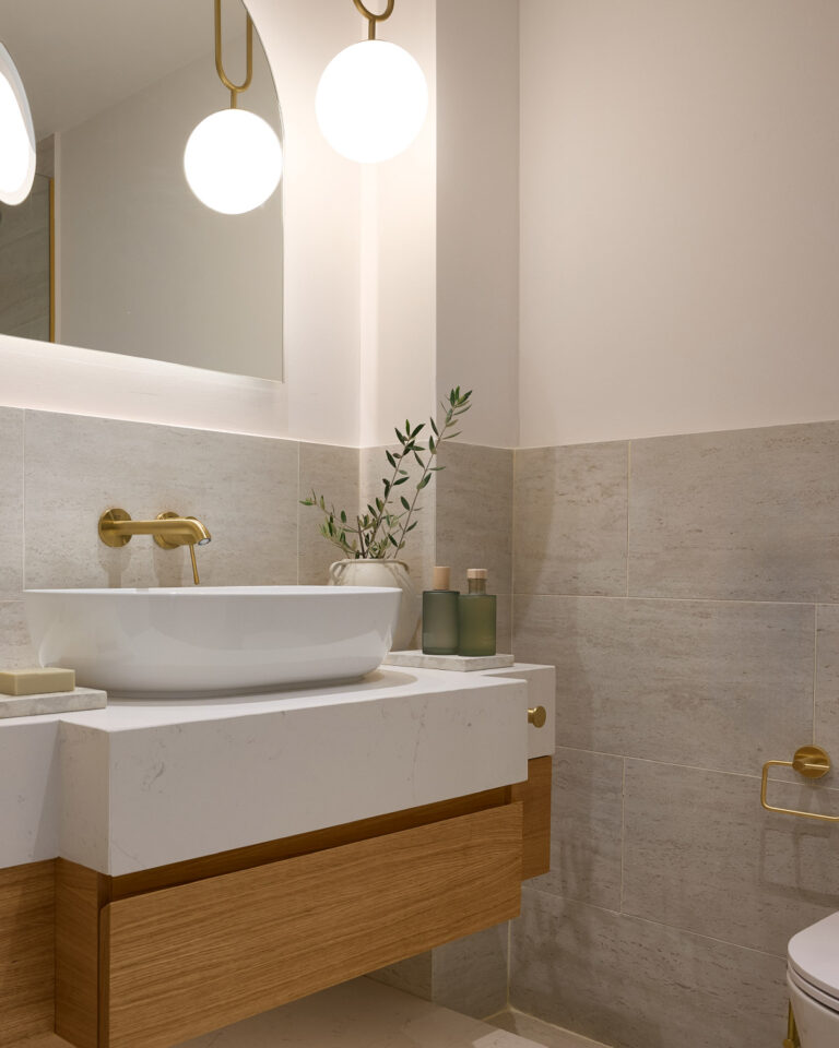 Deluxe Suite bathroom with marble vanity and brass fixtures