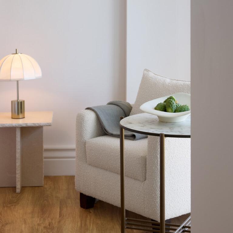 Armchair and side table details in the Deluxe Suite bedroom