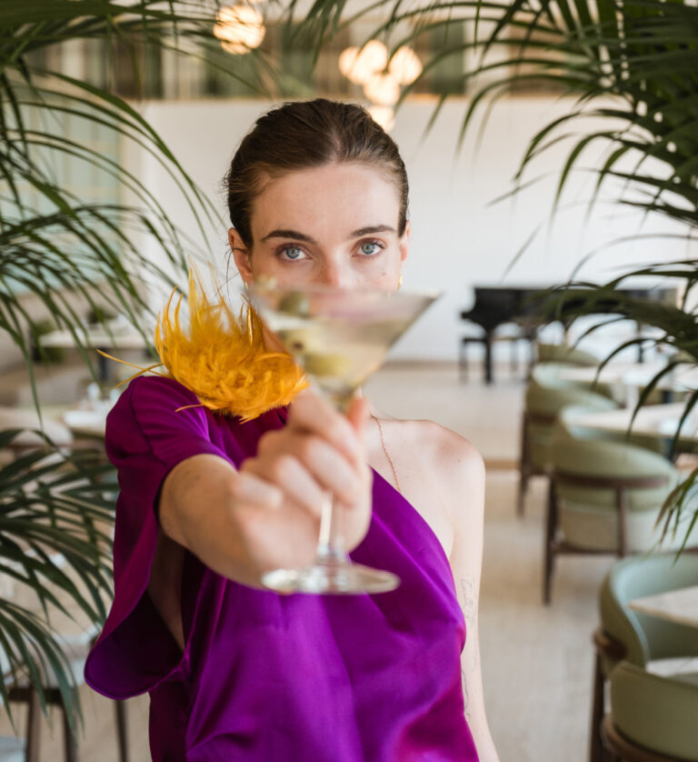 Woman enjoying a drink at Grecotel Filoxenia