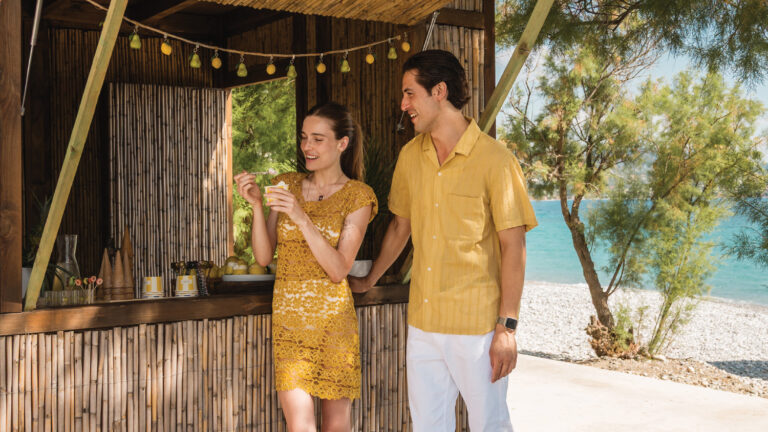 Couple enjoying drinks at a beachside kiosk