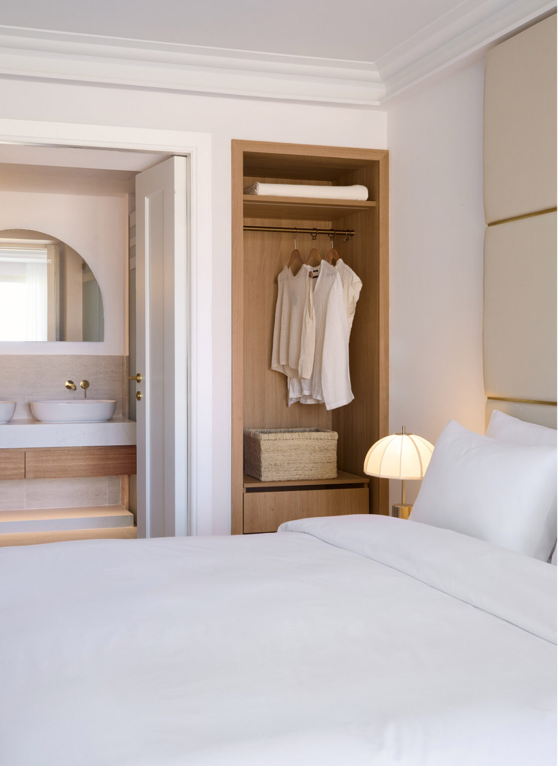 Deluxe Family Suite bedroom with open wardrobe and ensuite bathroom