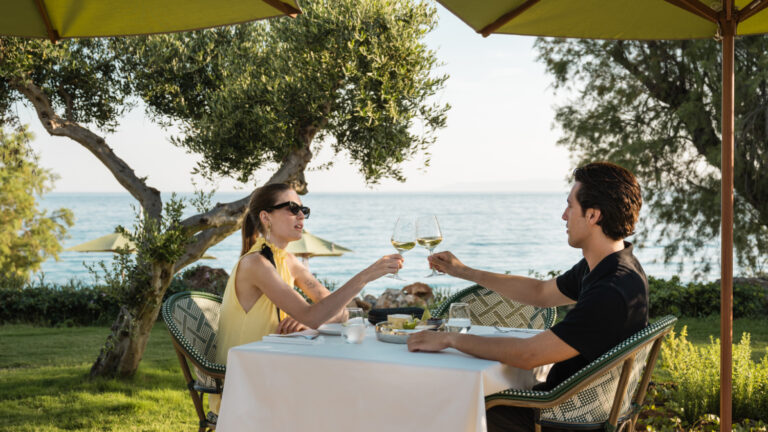 Couple enjoying seaside dining and wine at Filoxenia Kalamata