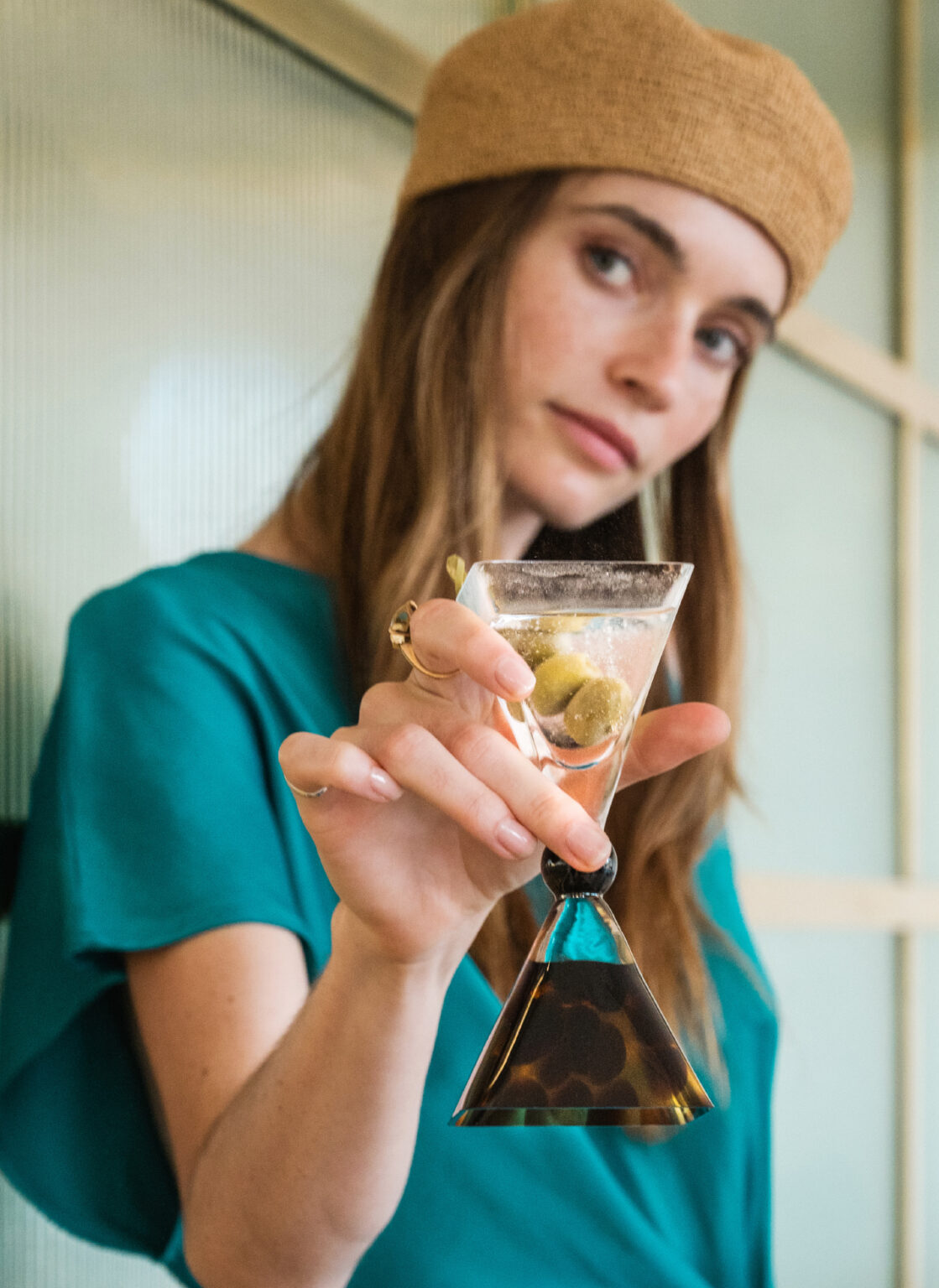 Woman holding a cocktail at Filoxenia Kalamata