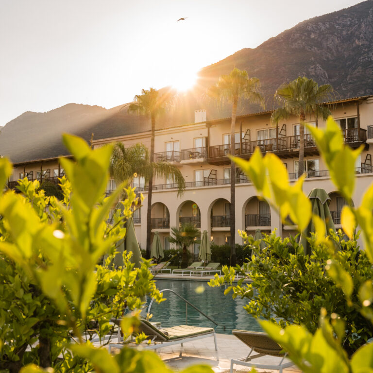 Grecotel Filoxenia Kalamata pool and hotel exterior at sunset