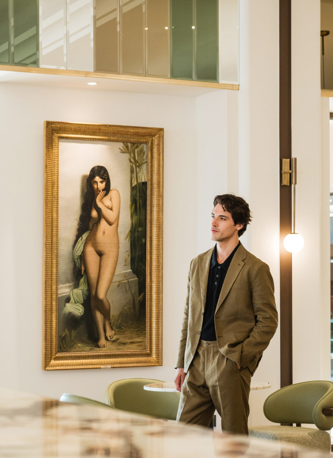 Guest viewing framed artwork in the hotel interior