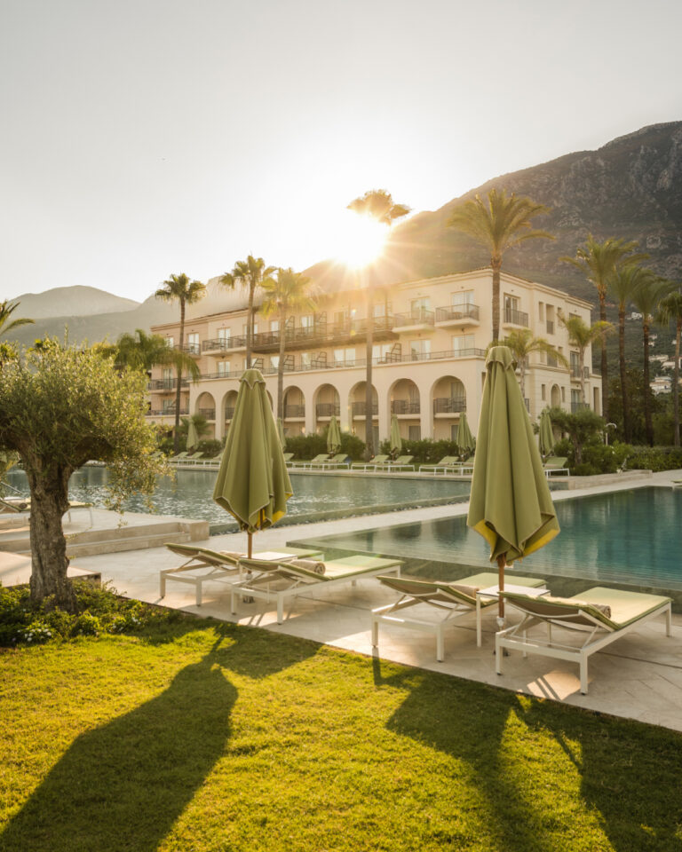 Filoxenia Kalamata outdoor swimming pools and hotel exterior at sunset