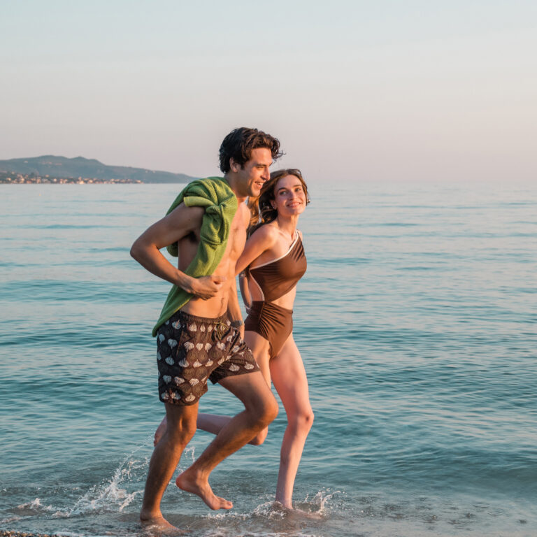 Couple walking along the beach at Grecotel Filoxenia Kalamata
