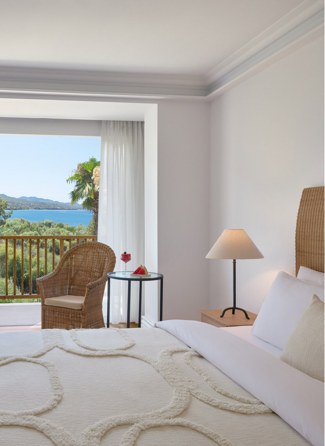 Superior Room bedroom with furnished balcony and side sea view