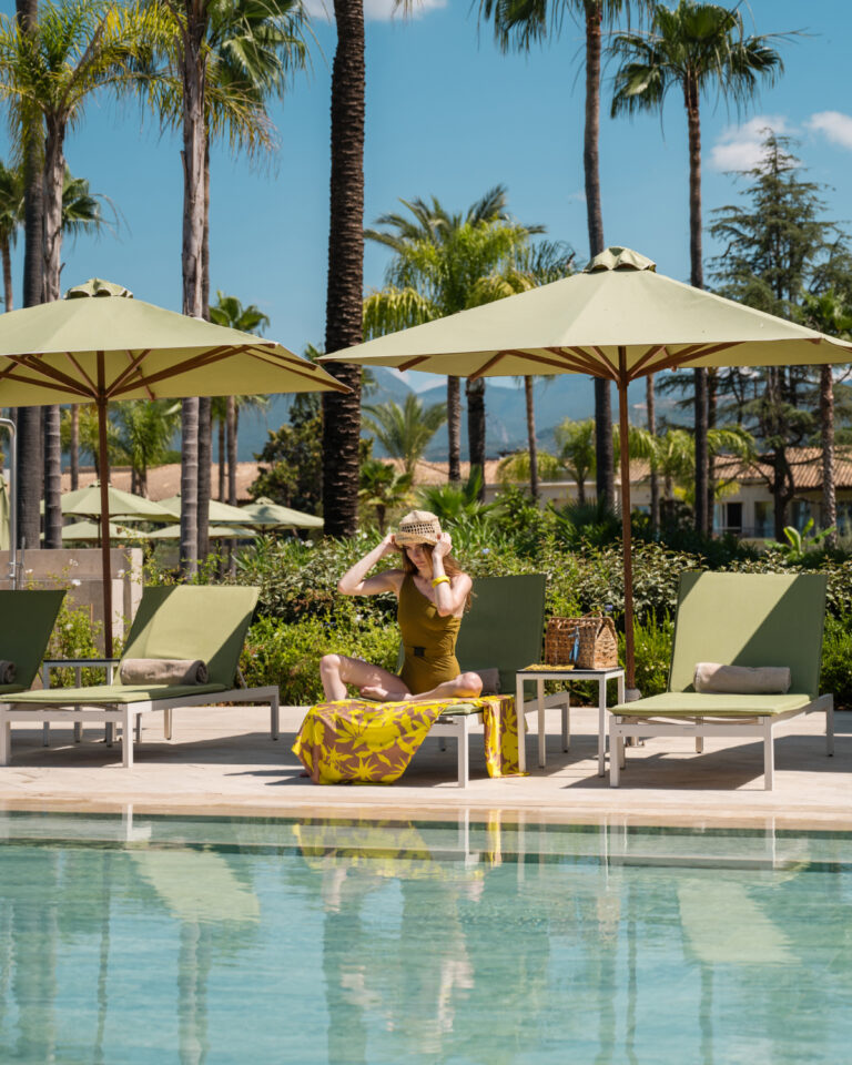 Woman relaxing by the pool at Grecotel Filoxenia Kalamata