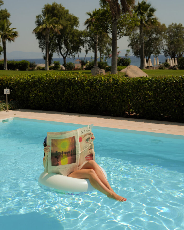Woman relaxing in the pool at Grecotel LUXME Kos