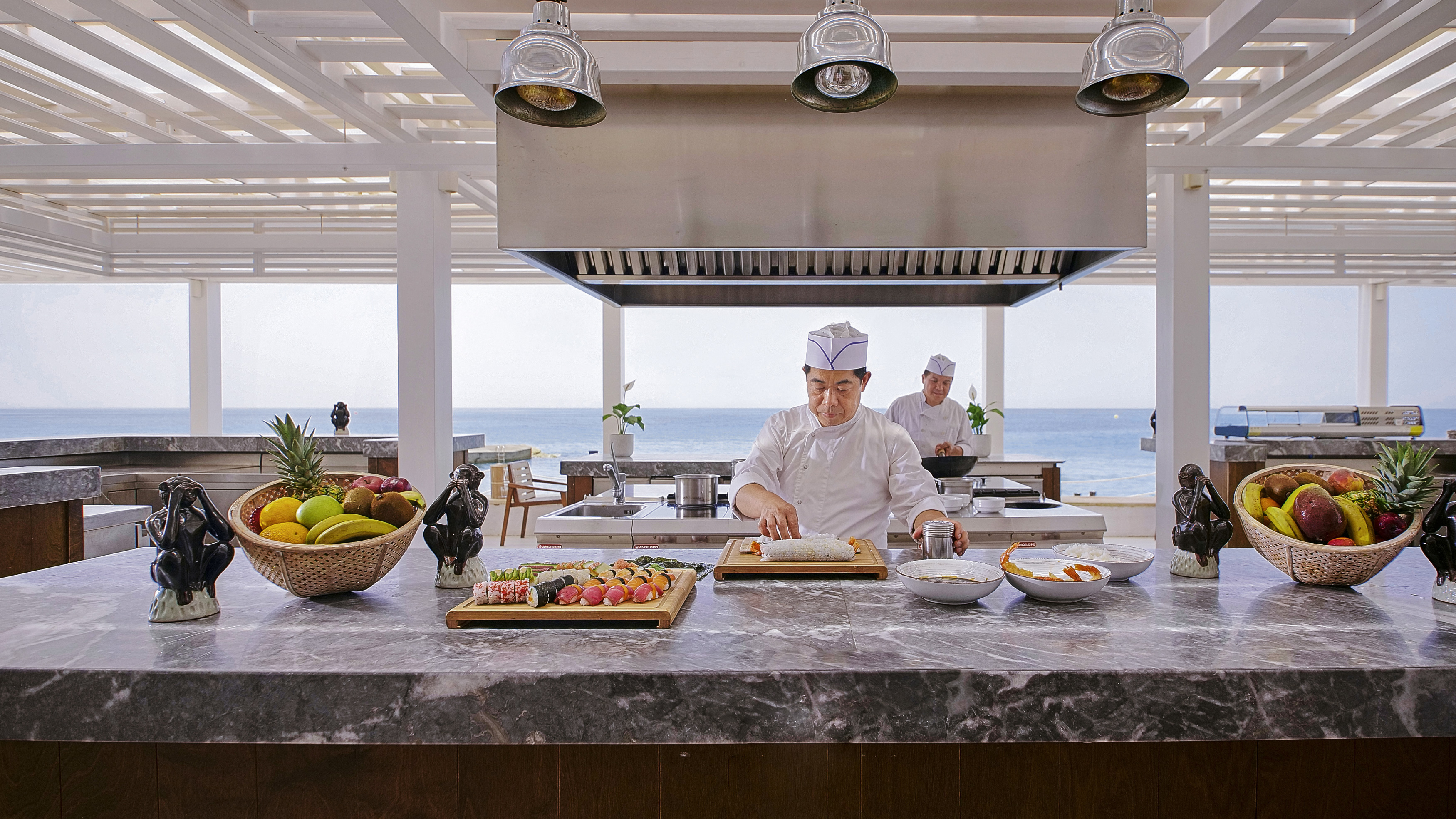 Chef preparing sushi at Asia White Restaurant overlooking the sea at Grecotel LUXME White Crete.