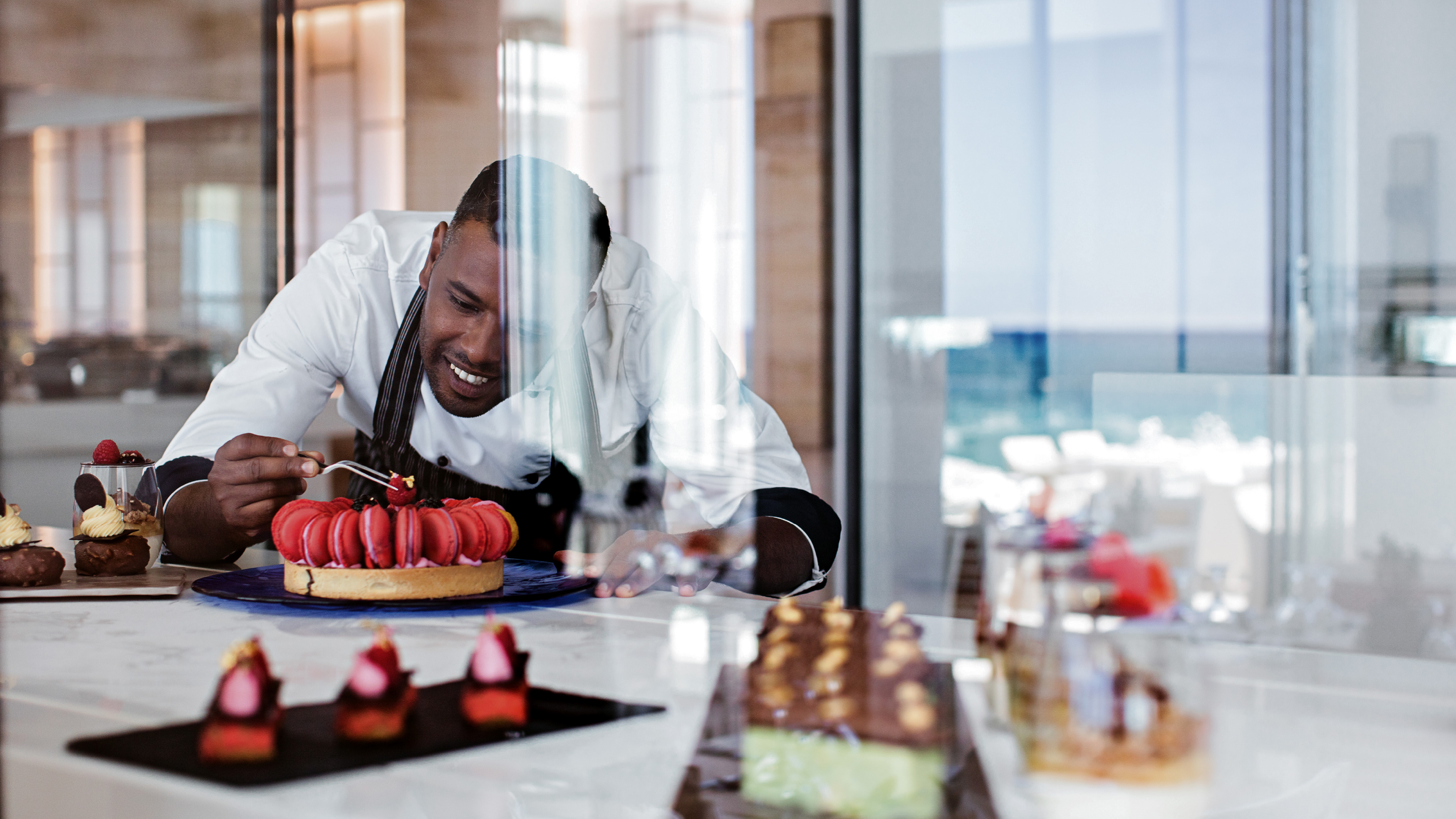 Pastry chef preparing desserts at Grecotel LUXME White Crete.
