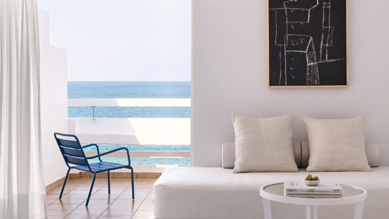 Grecotel LUXME White Crete Open-plan Suite seating area with sea view.
