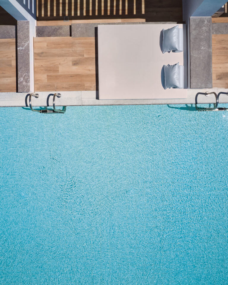 Grecotel LUXME White Crete swim-up pools with sunbeds, sea views and mountain backdrop