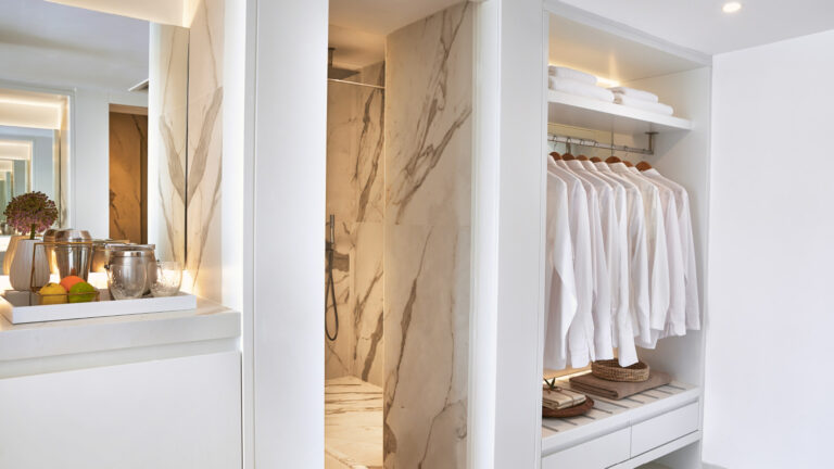 Grecotel LUXME White Crete Family Apartment bathroom shower and open wardrobe.