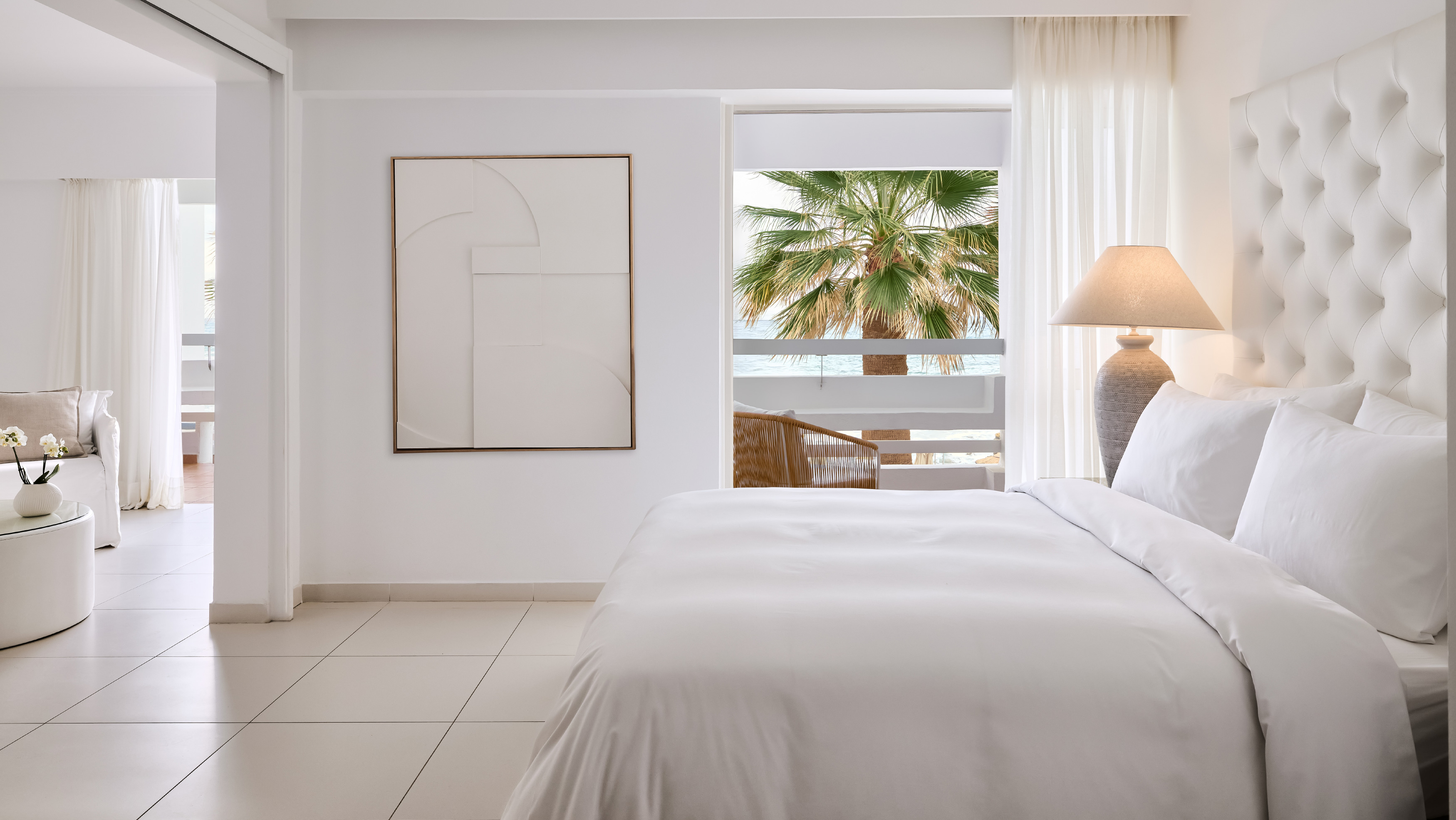 Grecotel LUXME White Crete White Family Suite bedroom with king bed, balcony and sea view.