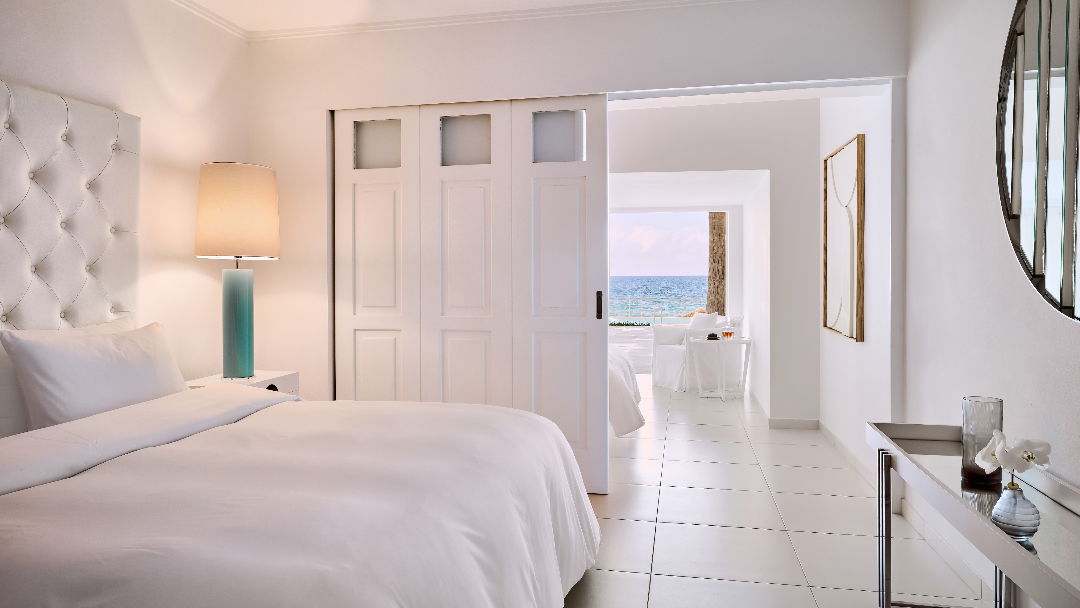 Grecotel LUXME White Crete Petit Yali Seafront Suite bedroom with sea view.