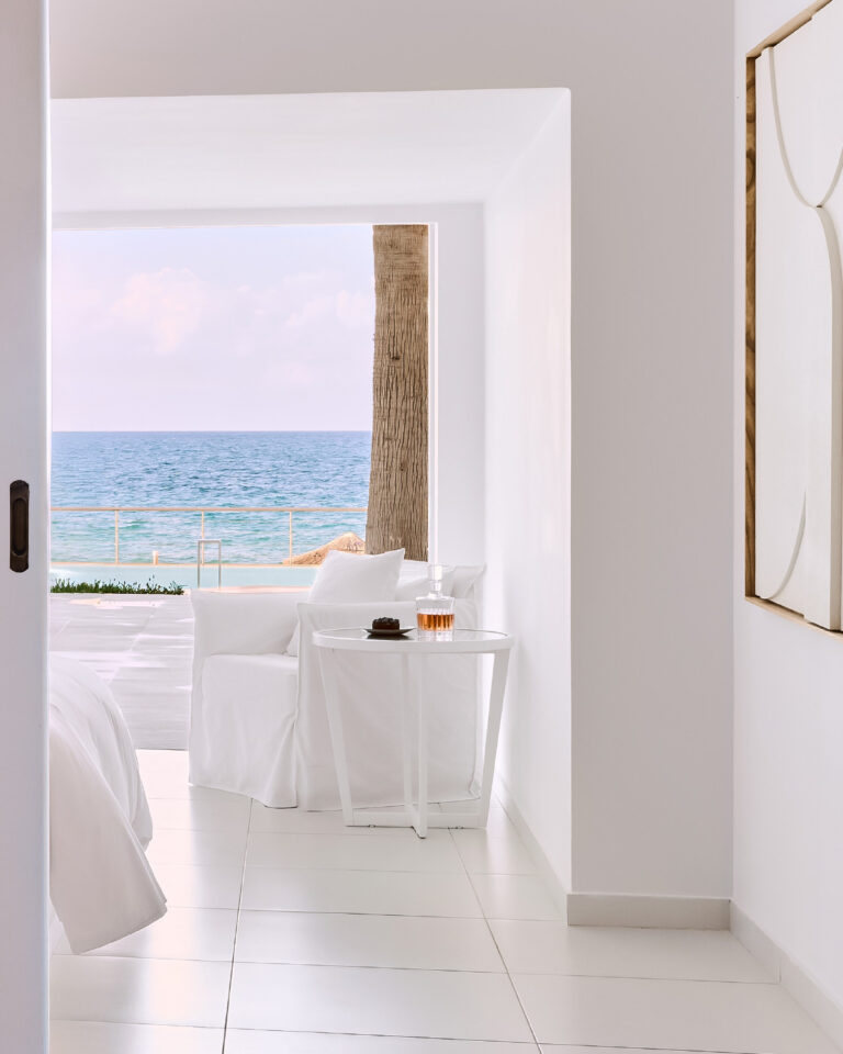 Grecotel LUXME White Crete Petit Yali Seafront Suite seating area with sea view.