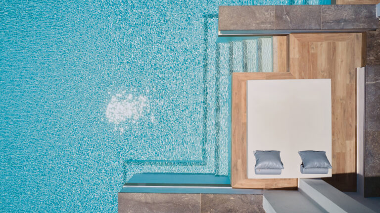 Grecotel LUXME White Crete Swim-up Family Guestroom pool with outdoor daybed viewed from above.