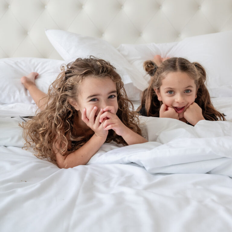 Children relaxing on a bed at Grecotel LUXME White Crete.