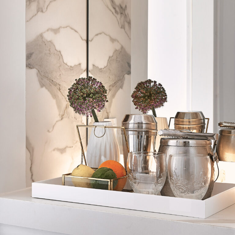 Grecotel LUXME White Crete Family Guestroom refreshments with fruit, drinks and decorative flowers.