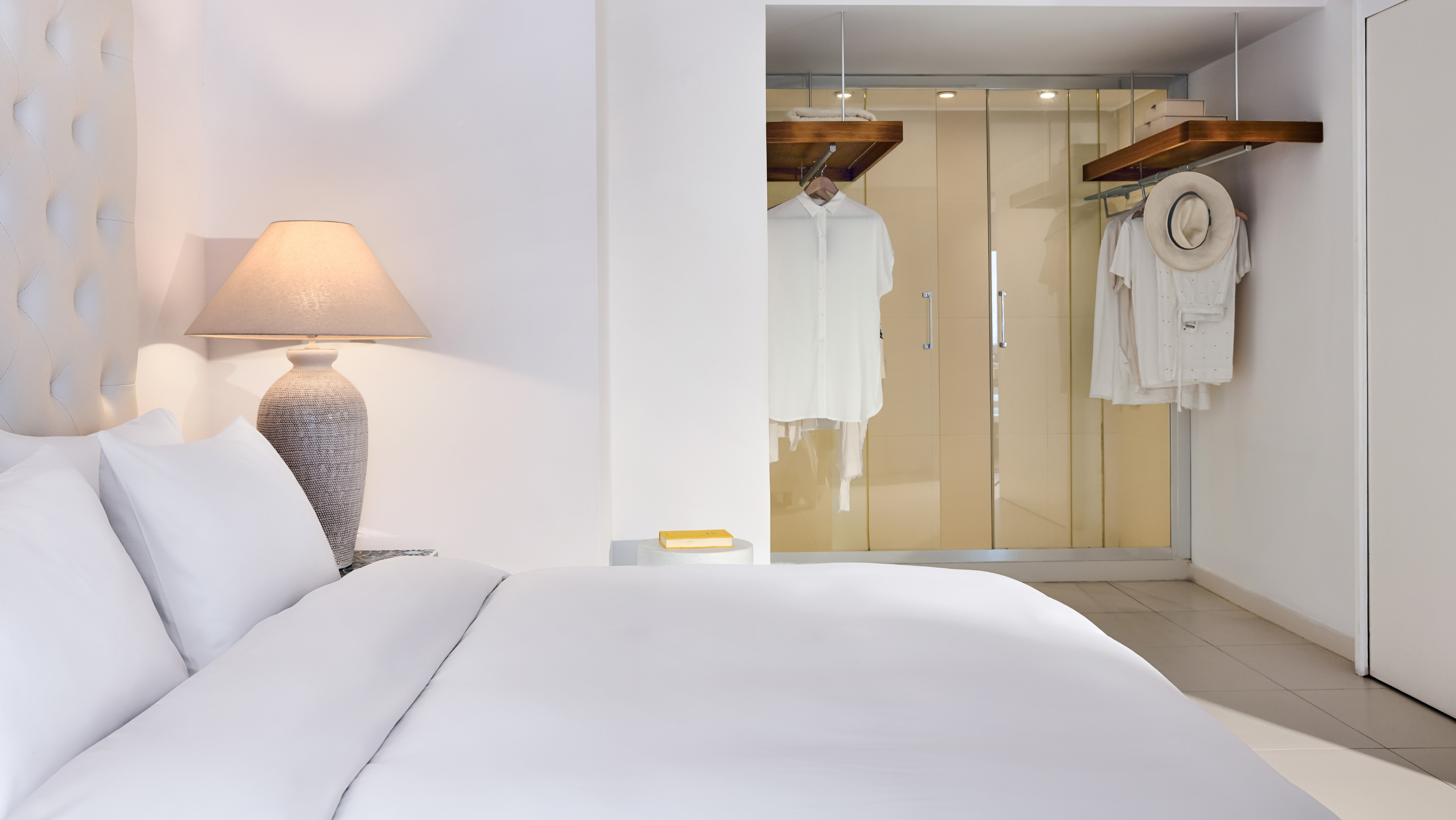 Grecotel LUXME White Crete White Family Suite bedroom with king bed and wardrobe.