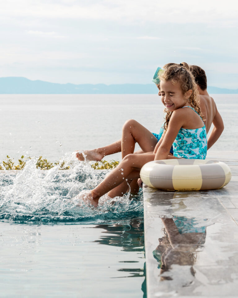 Children playing in the pool overlooking the sea at Grecotel LUXME White Crete.