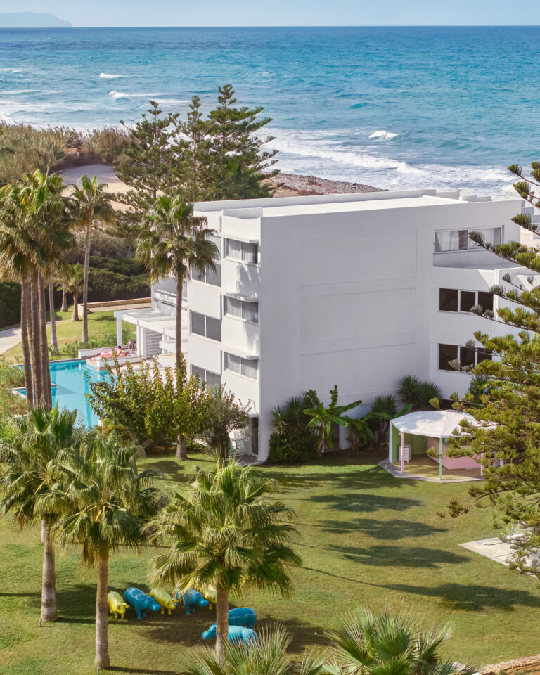 Grecotel LUXME White Crete resort buildings, gardens, pool and sea view.