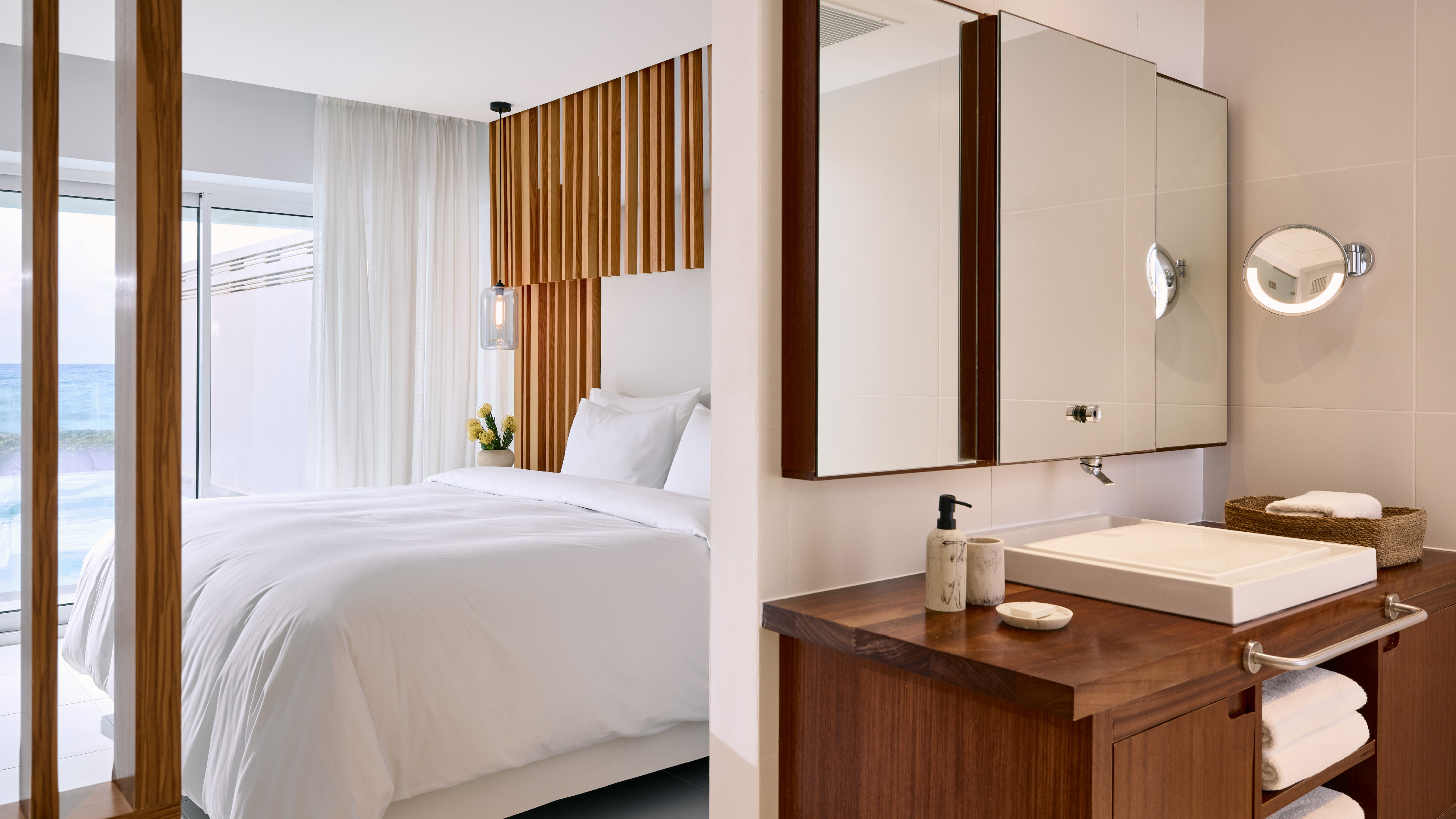 Grecotel LUXME White Crete Villa Luxe Yali bedroom and bathroom with sea view.