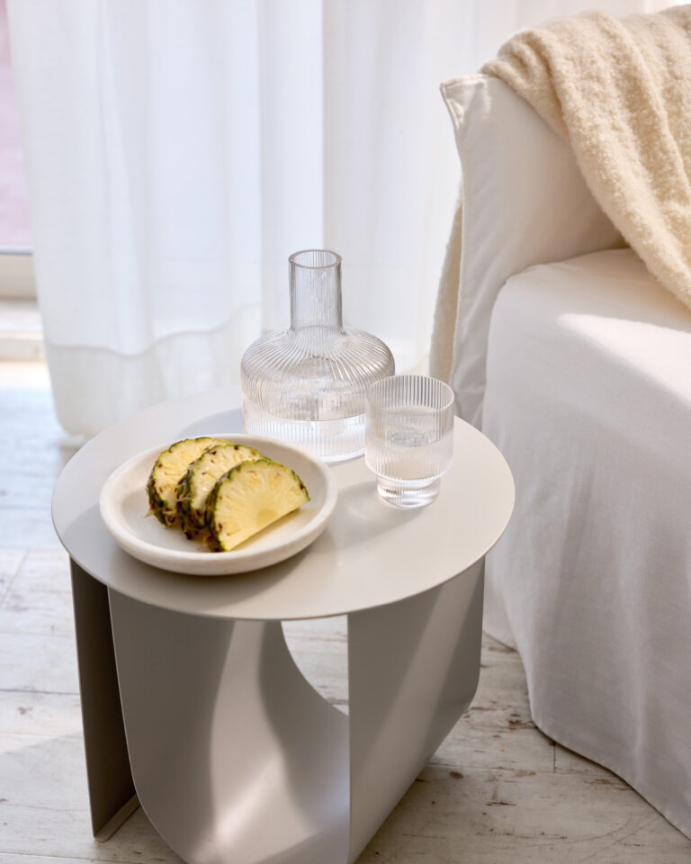 Grecotel LUXME White Crete Junior Suite seating area with pineapple and water.