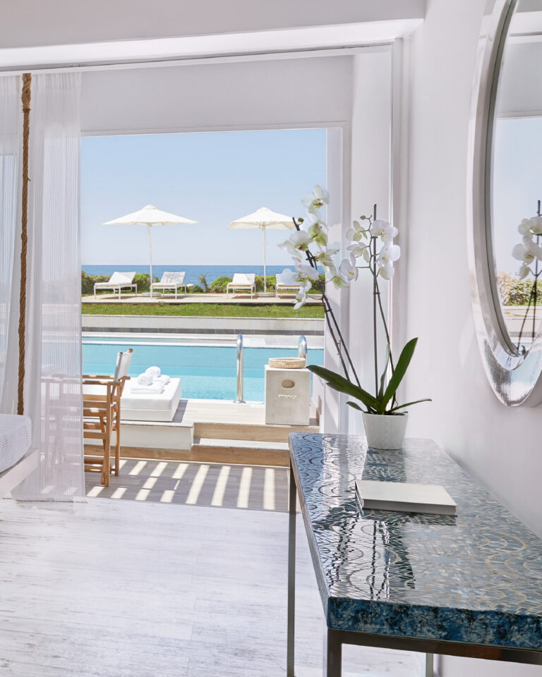 Grecotel LUXME White Crete swim-up guestroom with pool, sea view and outdoor sunbeds.