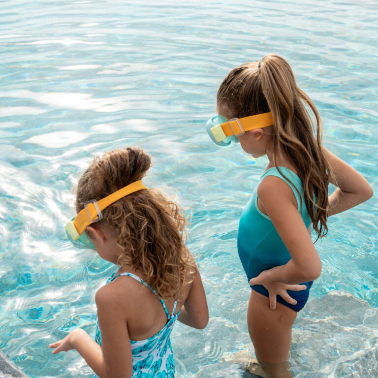 Children wearing swim goggles in the pool at Grecotel LUXME White Crete.