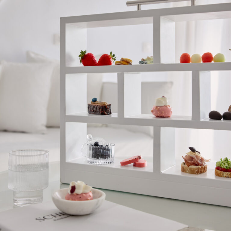 Fresh fruit and assorted desserts displayed in a Grecotel LUXME White Crete Yali Seafront Suite.