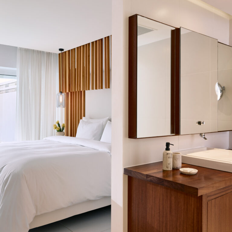 Grecotel LUXME White Crete Villa Luxe Yali bedroom and bathroom with wooden details.