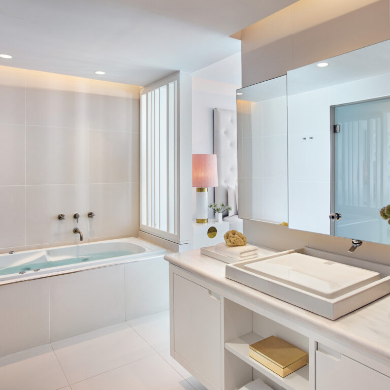 Grecotel LUXME White Crete Villa Luxe Yali bathroom with bathtub, double vanity and mirror.