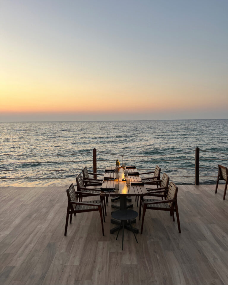 Seafront dining terrace overlooking the sea at sunset at Grecotel LUXME White Crete.
